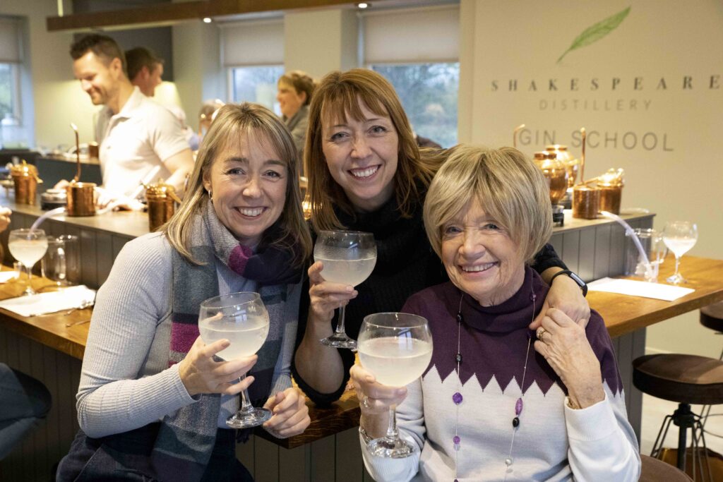a photo of three women holding drinking glasses